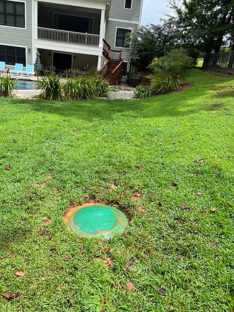 Completed septic riser installation with green lid flush in a homeowner's yard in Rock Hill SC — clean, discreet, and easy to access