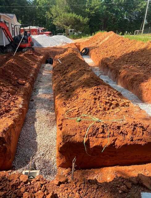 DLC Septic drainfield gravel bed installation with proper drainage layers in Lancaster County SC