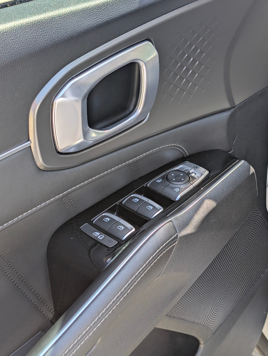 Professional interior detailing showing pristine door panel cleaning, window controls, and interior trim conditioning on modern SUV