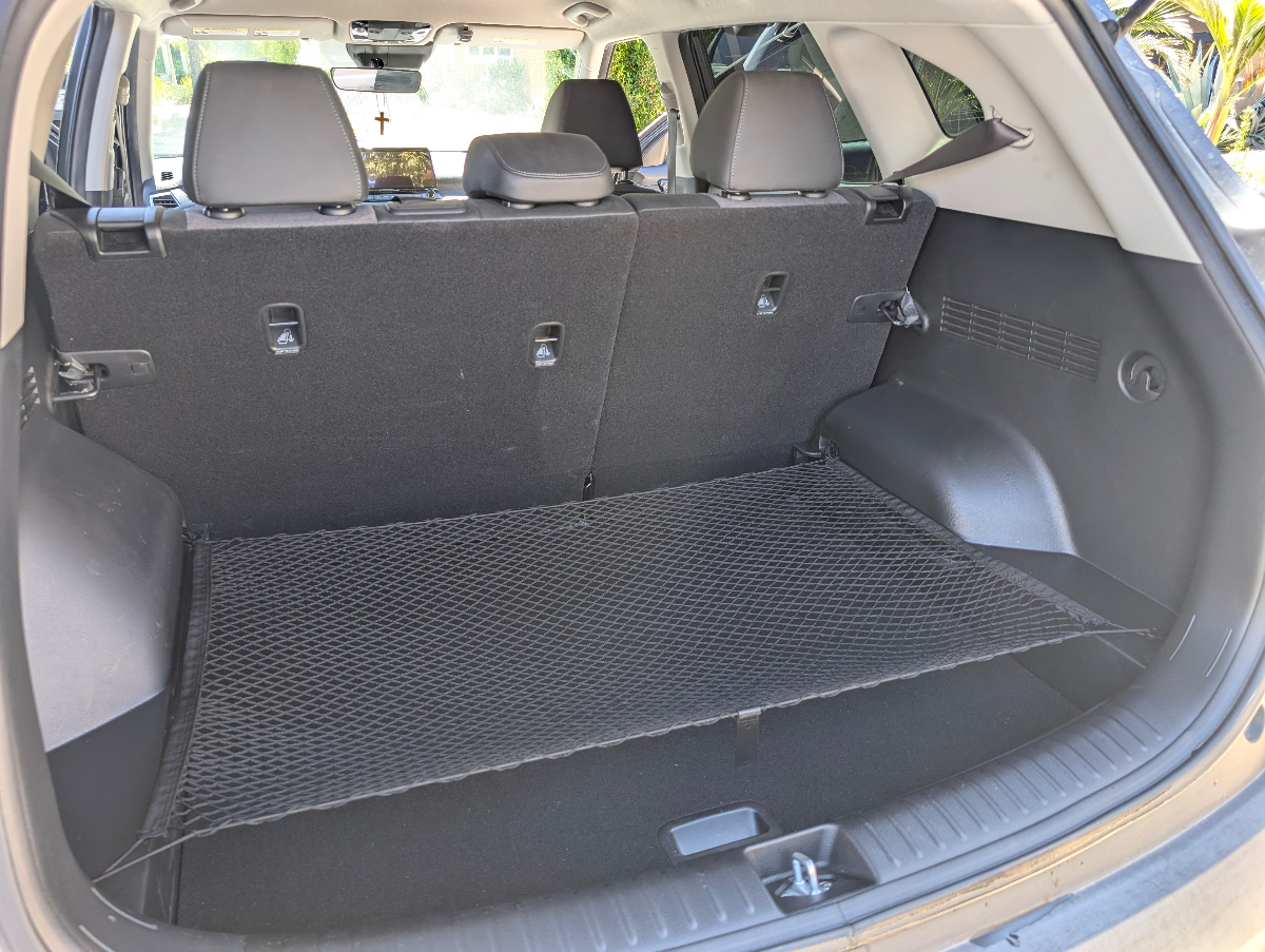 Professional cargo area detailing of Kia Seltos showing immaculate carpet cleaning, pristine trim work, and organized cargo space with complete attention to detail