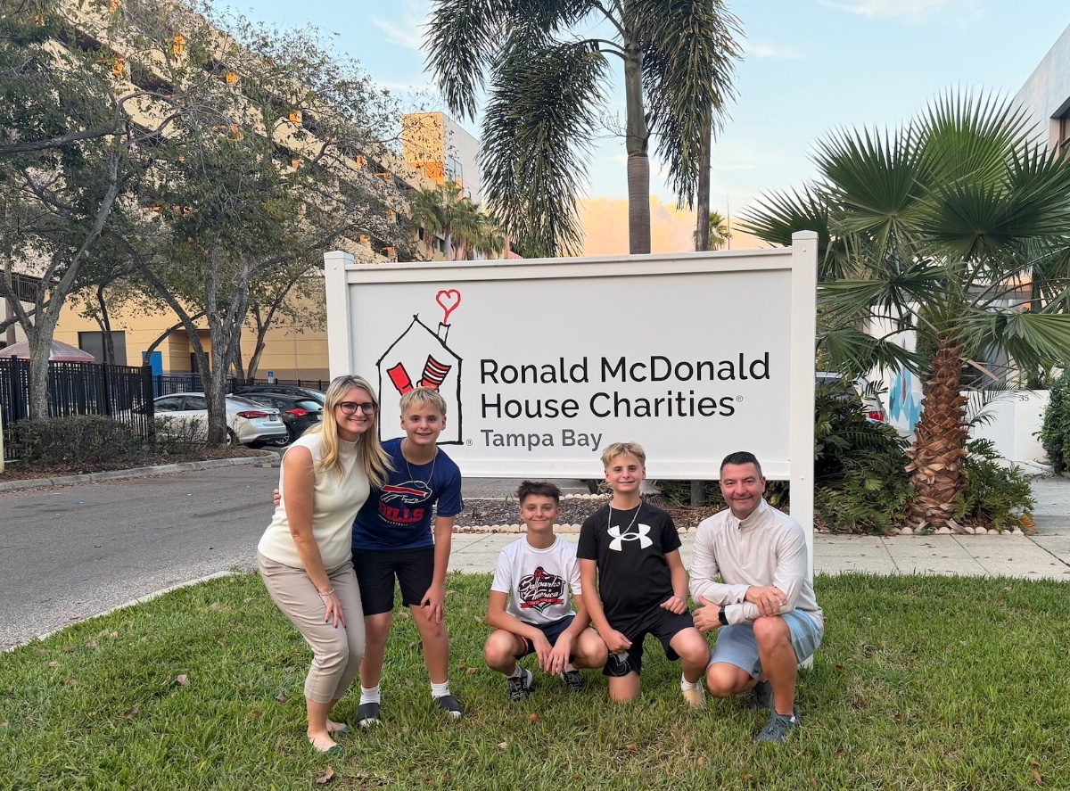 The Mastykarz family smiling in front of the Ronald McDonald House Charities Tampa Bay sign