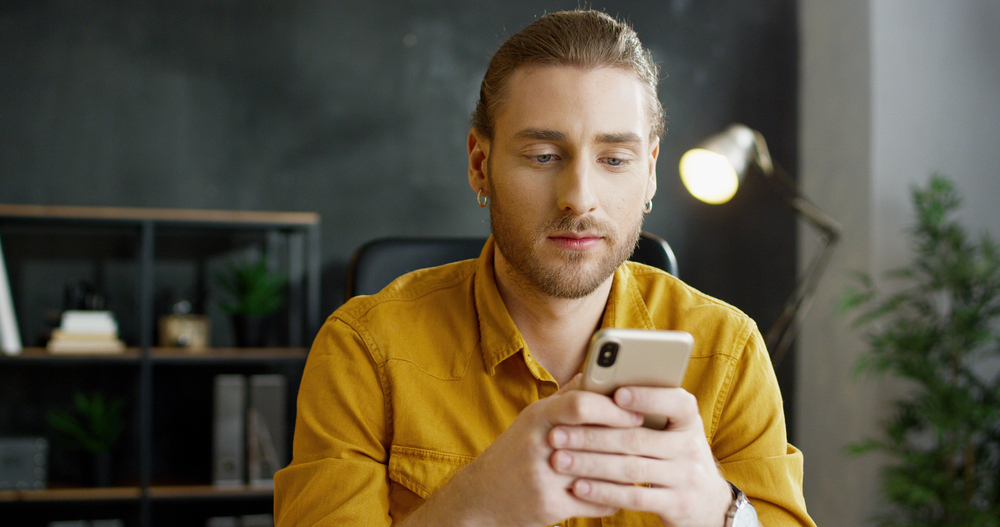 Person using laptop computer engaging with real estate website chat assistant for instant lead response