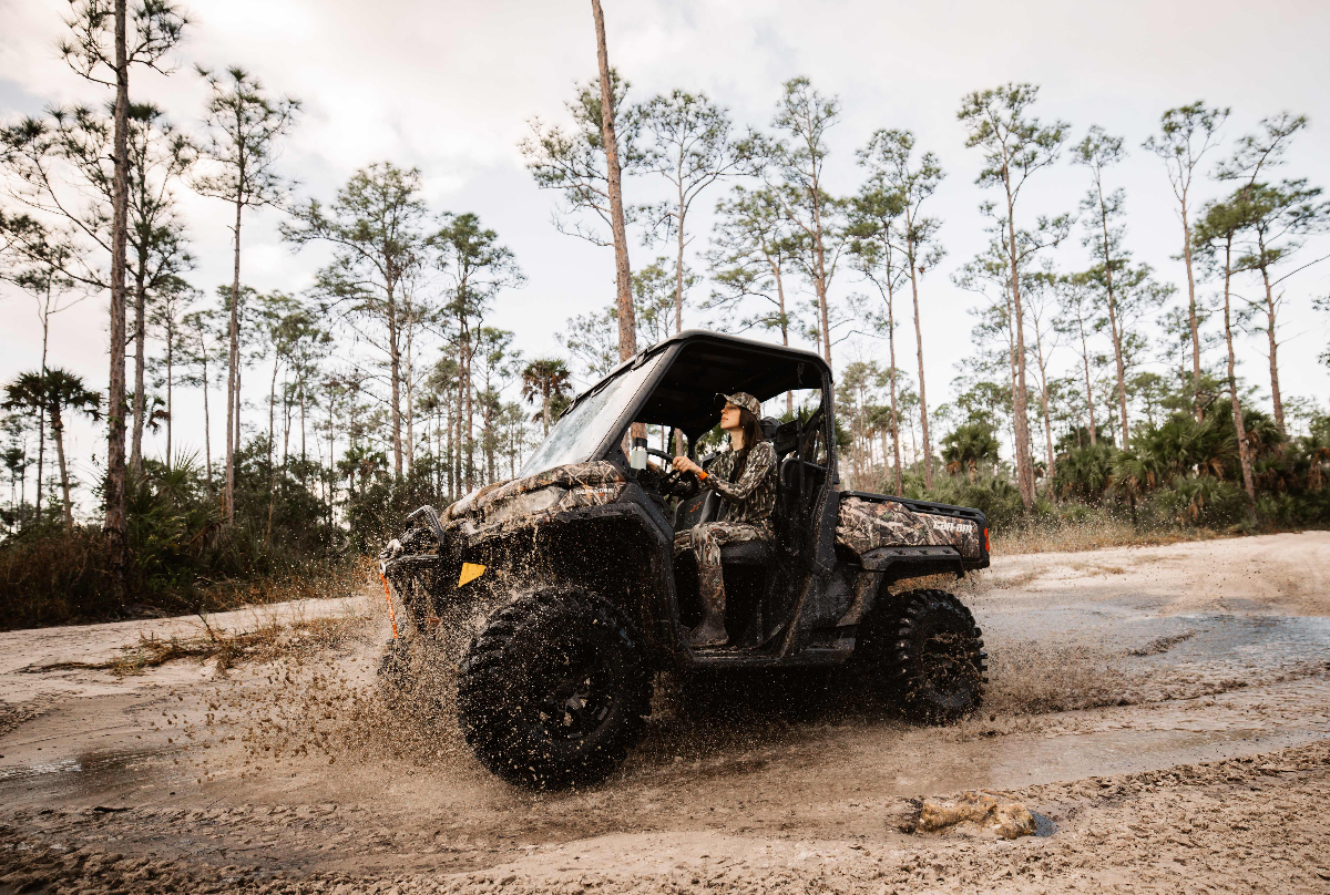 Allie driving off-road vehicle through Florida wilderness