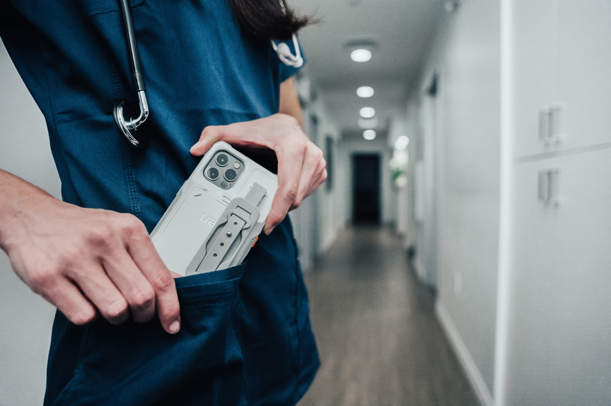 Healthcare worker with UAG Workflow Series case in hospital hallway
