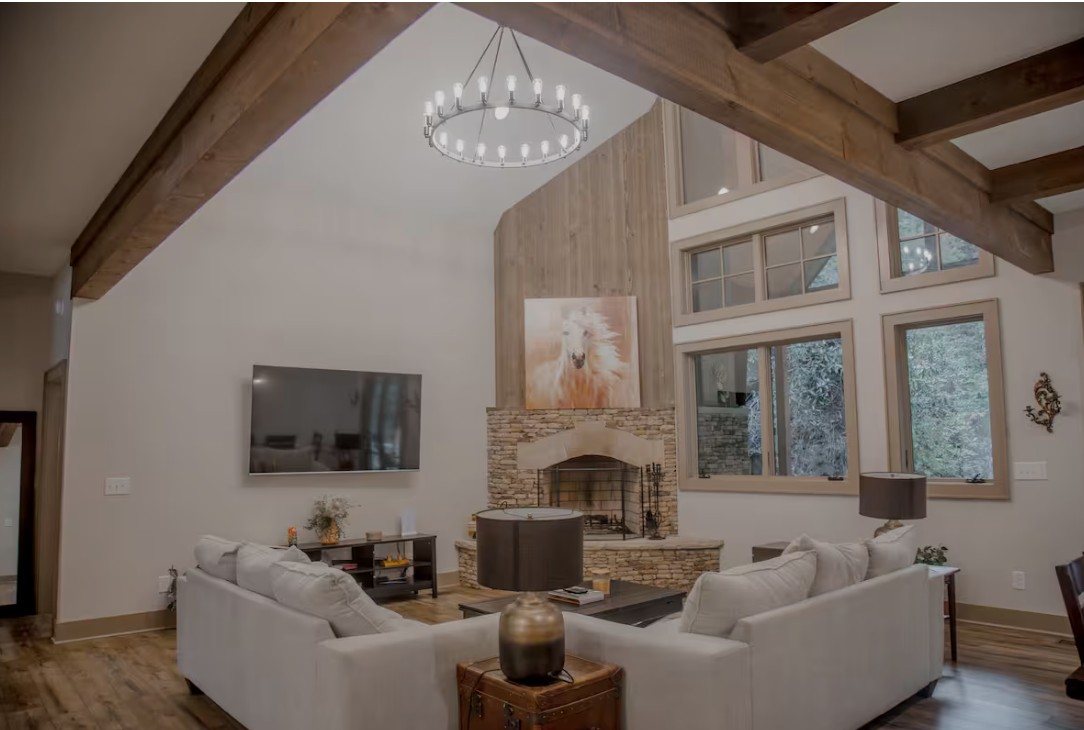 Glen Falls Luxury Cabin in Highlands, NC — interior living room with stone fireplace