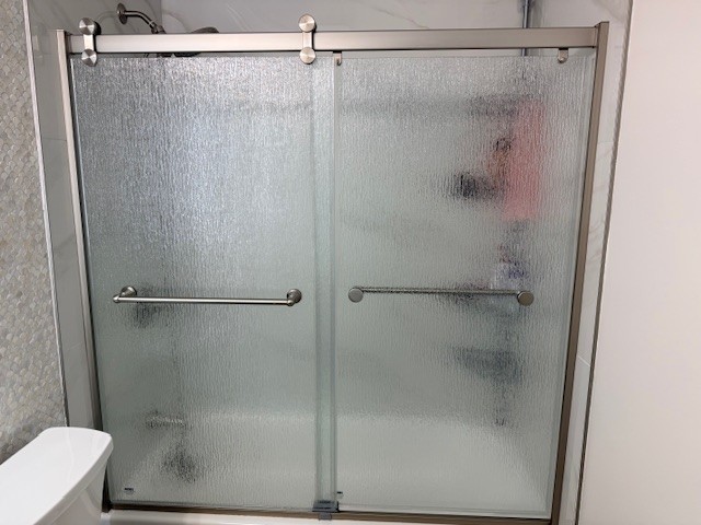 Frameless sliding shower door installation