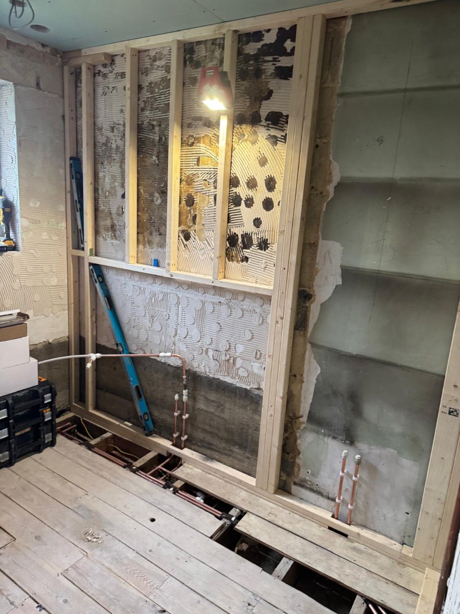 Stud wall framework and plumbing rough-in during renovation