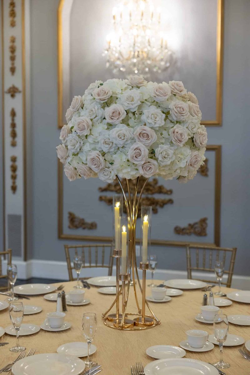 White Hydrangea with White and Beige Roses on Gold Hourglass Stand with Gold Taper Candle Holders