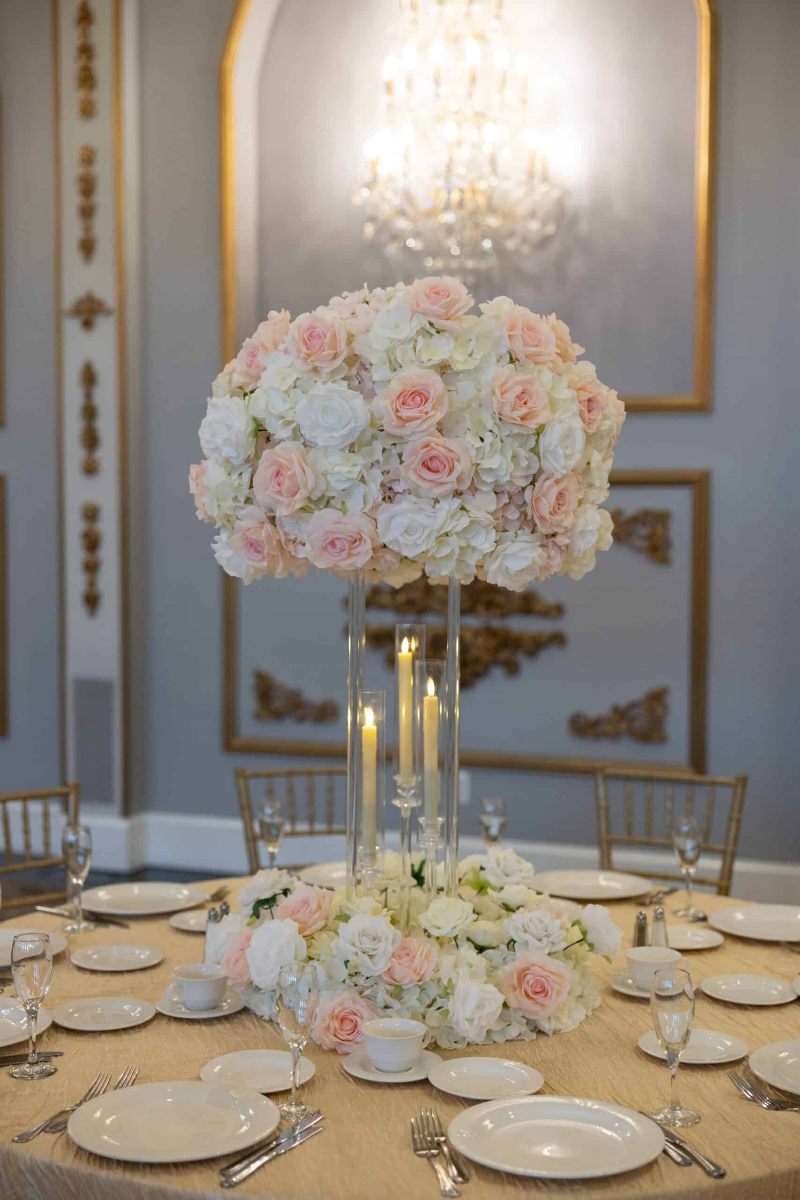 White Hydrangea with white and blush roses on Clear Harlow Stand with Taper Candle holders and Wreath