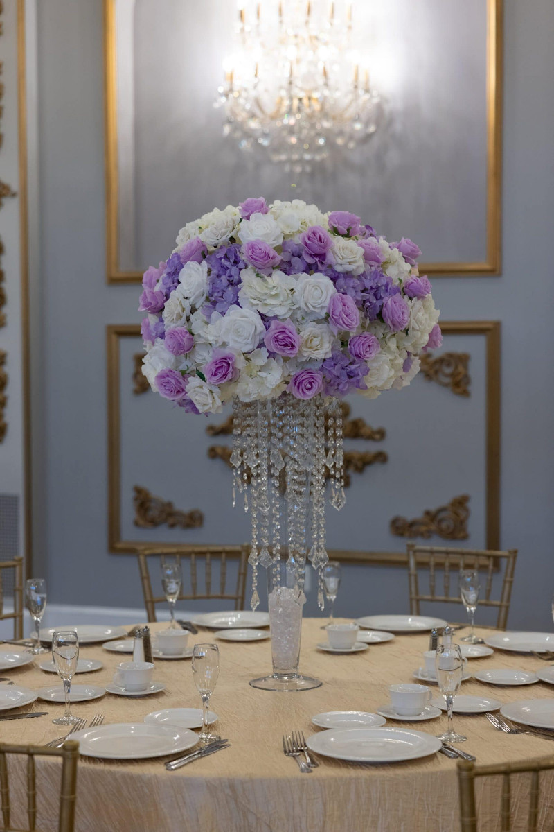 White Hydrangea and White and Lavender roses on pilsner vase with princess Chandelier
