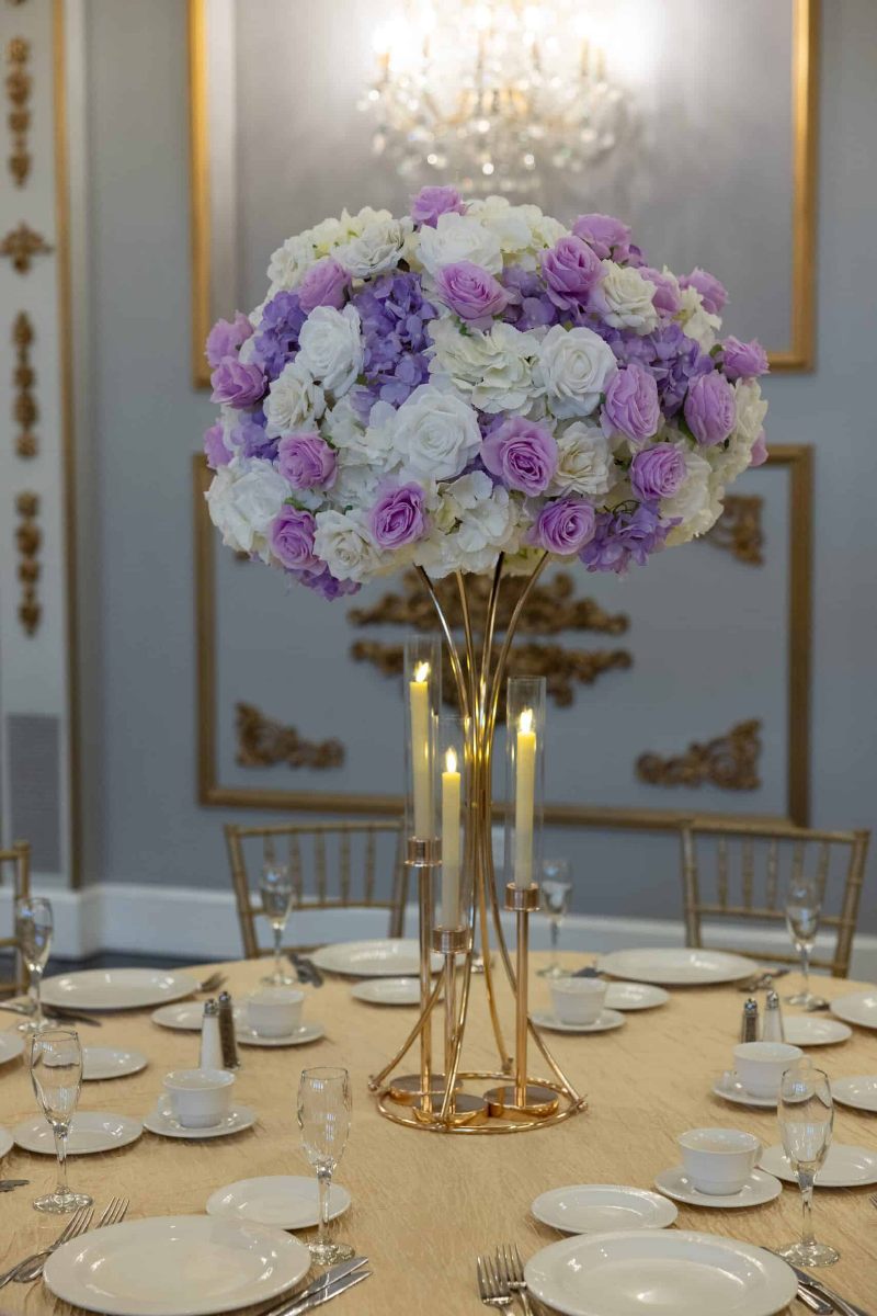 White Hydrangea and White and Lavender roses on Gold Hourglass stand with taper candle holders
