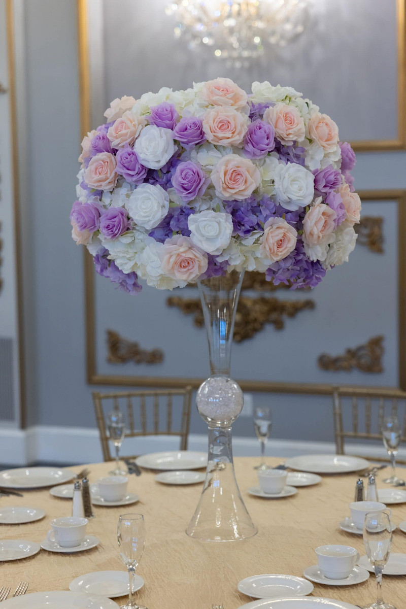 White Hydrangea with white, pink and lavender roses on hourglass vase