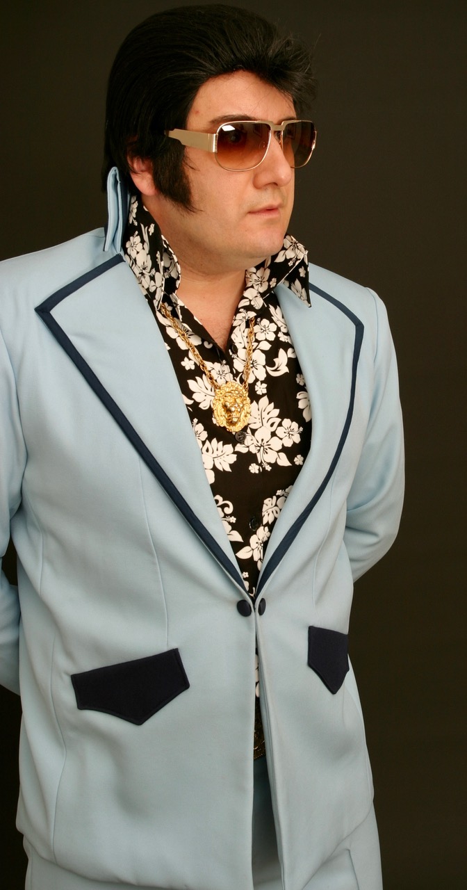 Elvis tribute performance in white jumpsuit
