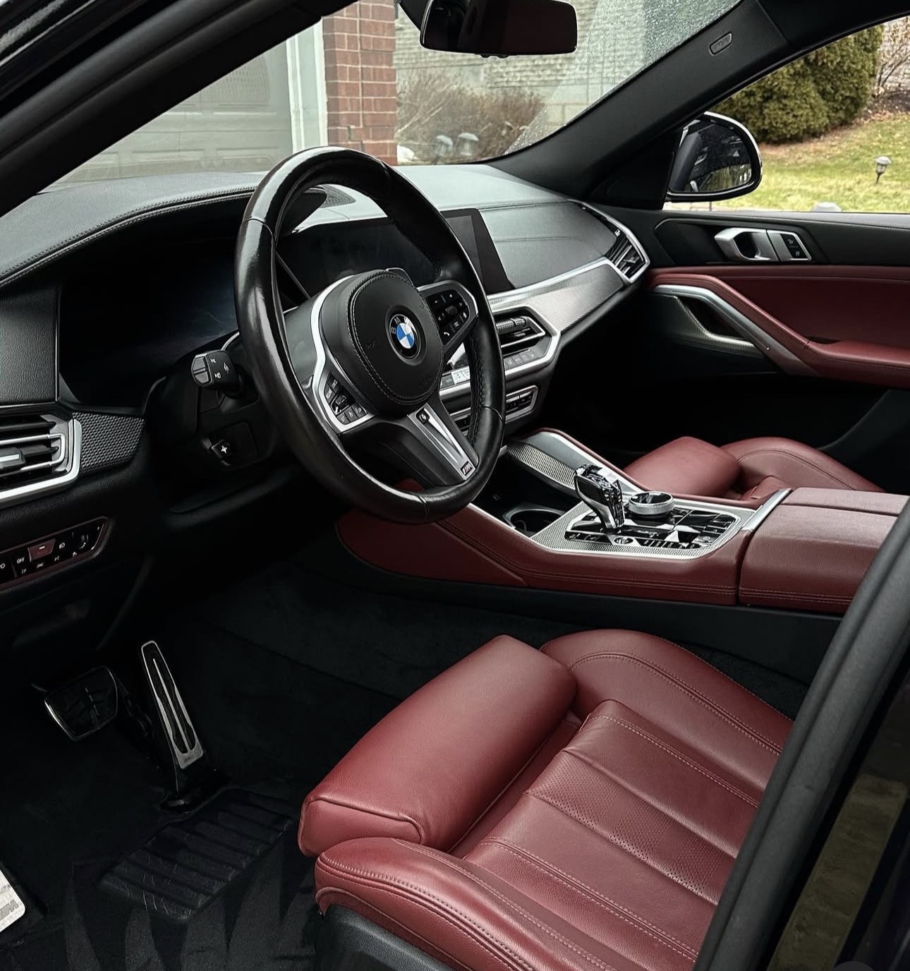 Professional mobile auto detailing technician working on luxury vehicle with premium equipment and products in driveway setting, showcasing Imperial Mobile Detailing's professional service quality and attention to detail
