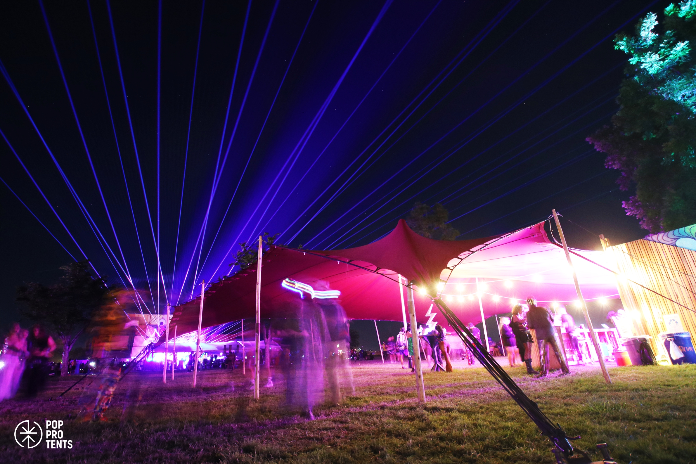 Electronic music festival under stretch tent at night