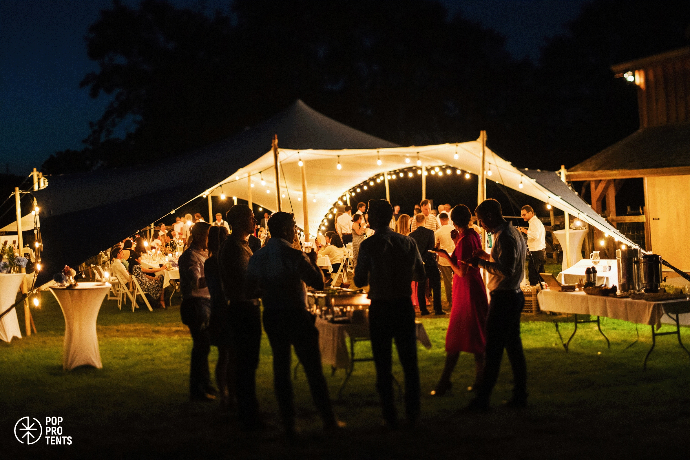 Luxury wedding reception under stretch tent with chandeliers