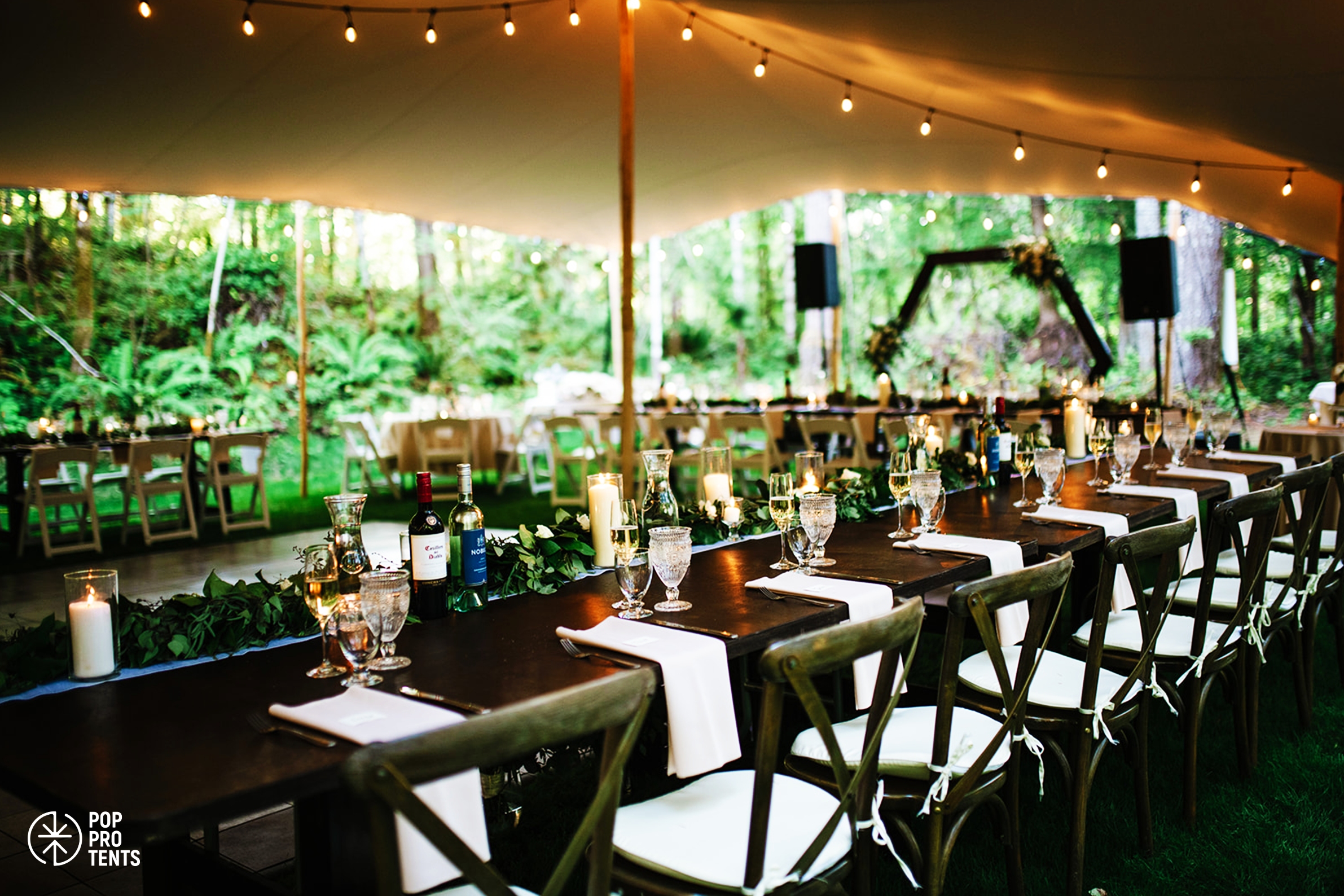 Countryside wedding ceremony under stretch tent