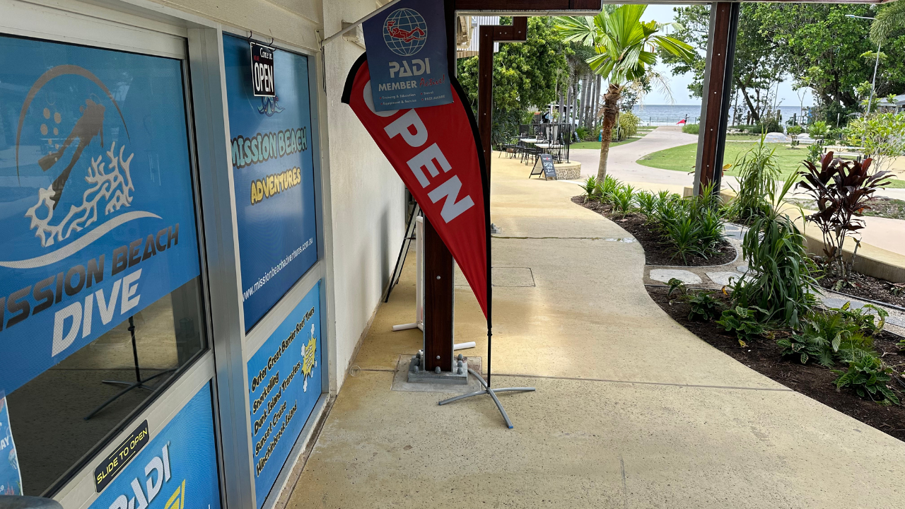 Aerial view of Mission Beach coastline with turquoise Great Barrier Reef waters