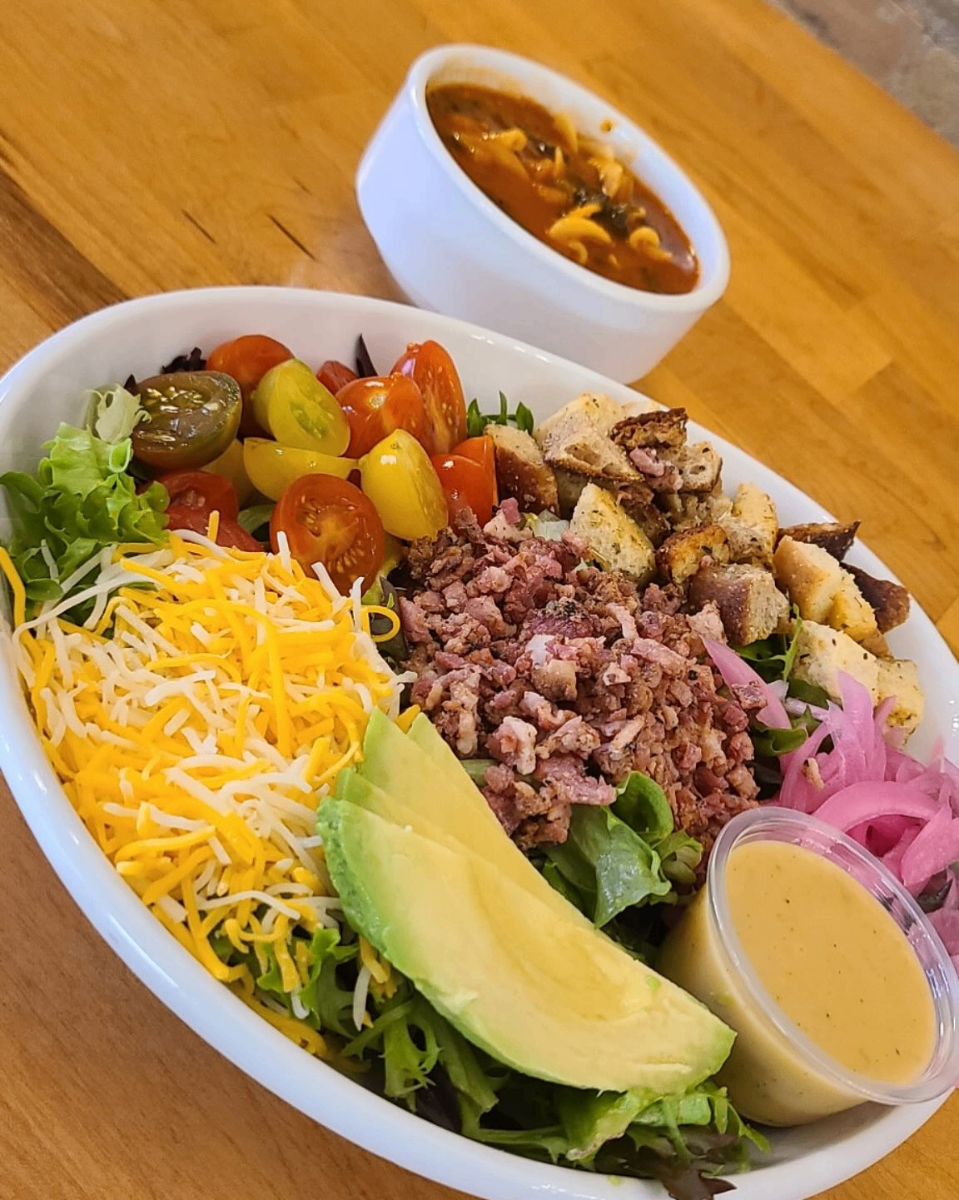 Loaded salad bowl with ground meat, avocado, cheese, and heirloom tomatoes