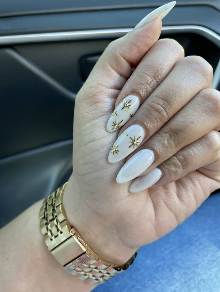 White almond nails with gold star accents