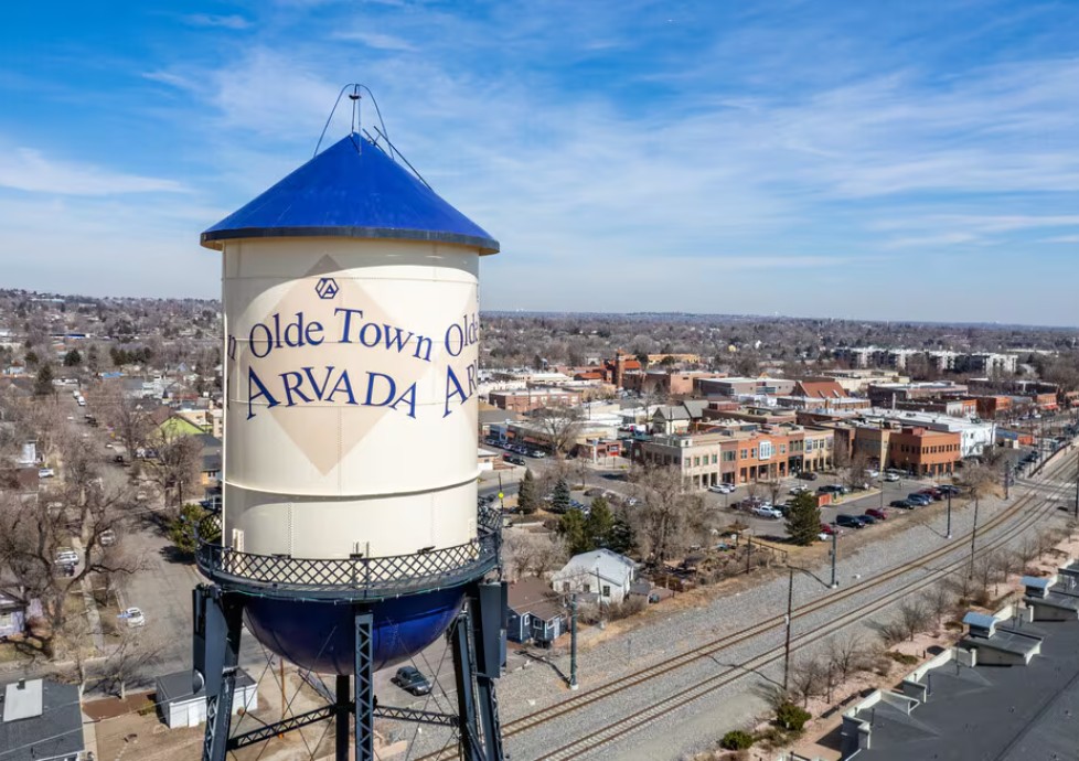 Olde Town Arvada Water Tower with the Rocky Mountains in the background
