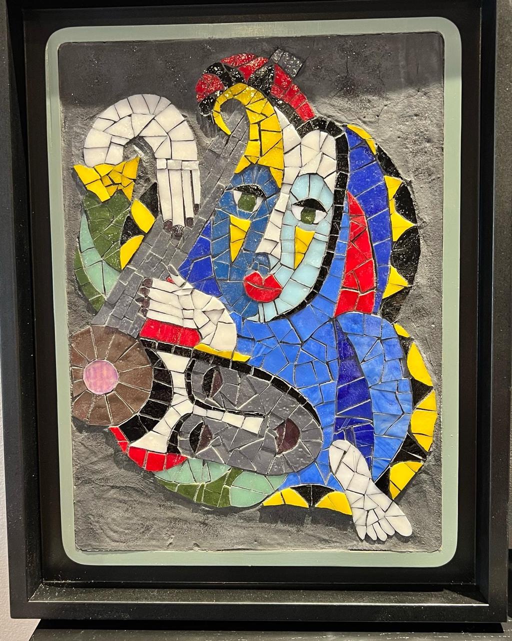 Group of happy workshop participants showing their mosaic creations