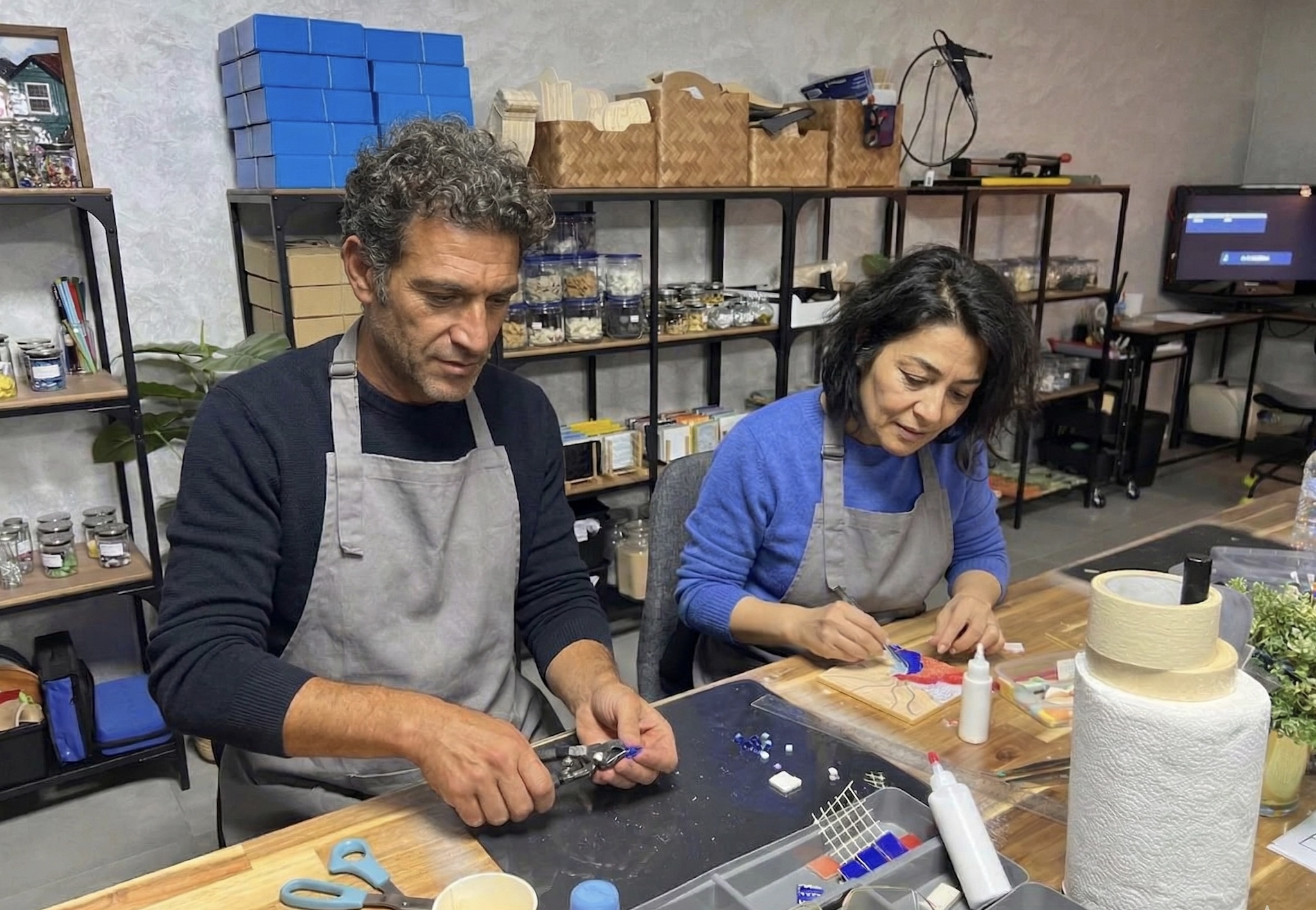 Focused artisan hands carefully placing ceramic tesserae in precise mosaic pattern Focused artisan hands carefully placing ceramic tesserae in precise mosaic pattern