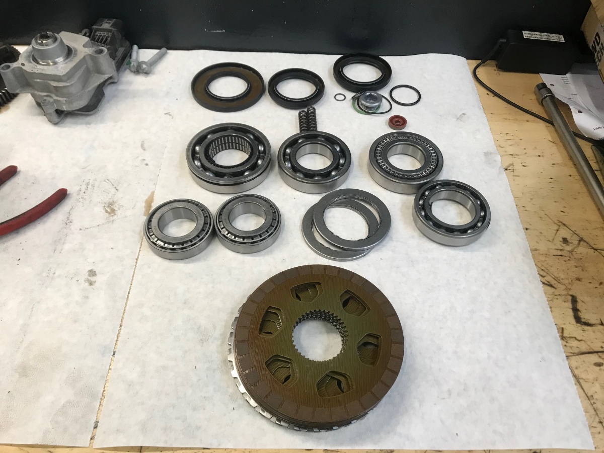 BMW xDrive transfer case rebuild components — bearings, seals, clutch pack laid out before reassembly