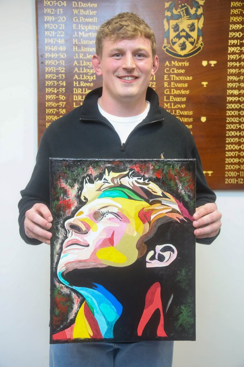Wales Rugby Captain Jac Morgan holding his custom PopDragon Art portrait at Cwmtwrch R.F.C