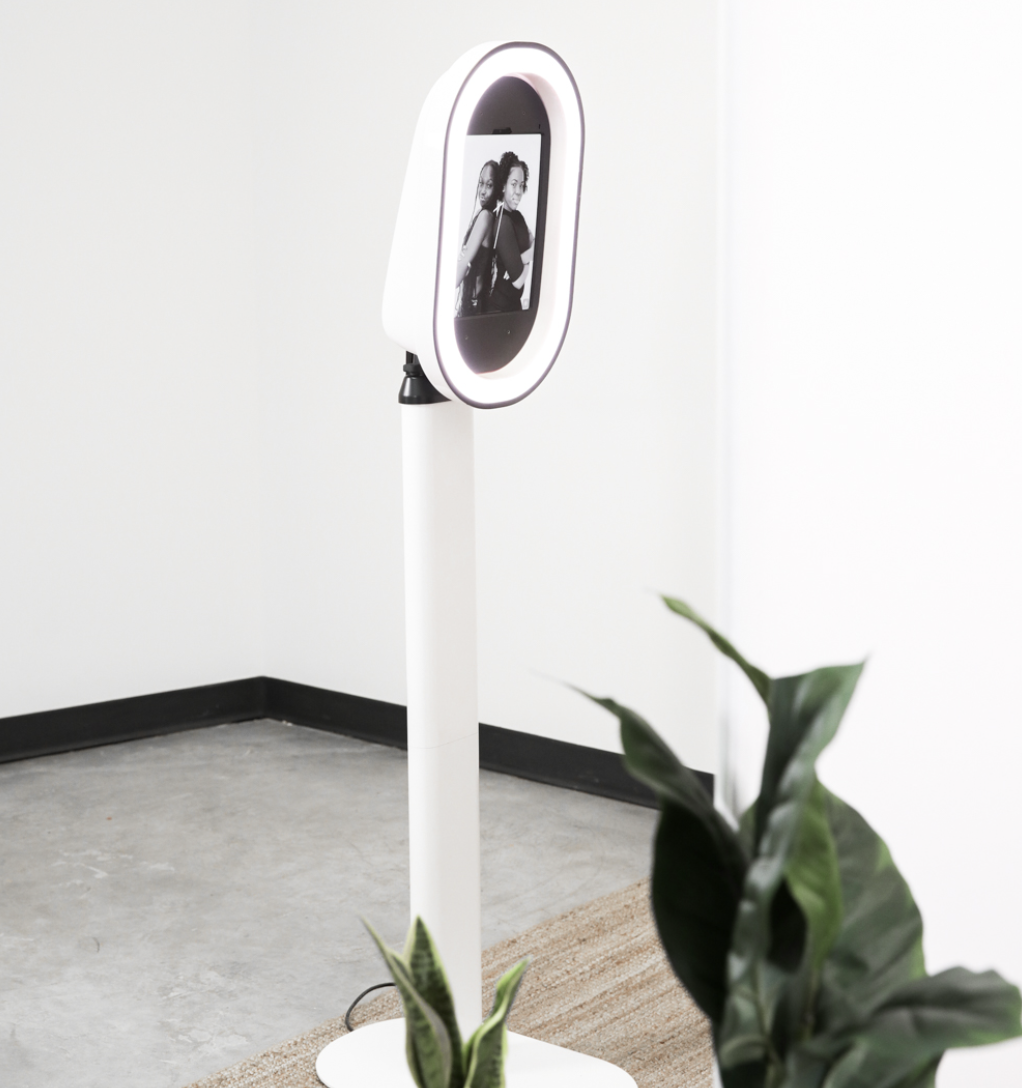 Wedding guests enjoying photo booth with fun props and poses