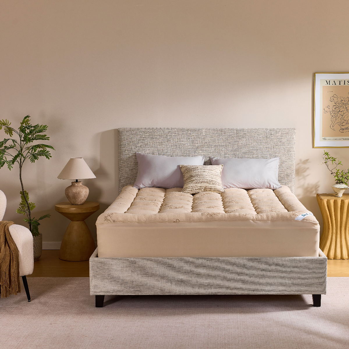 Bamboo mattress topper dressed on a bed in a warm neutral bedroom