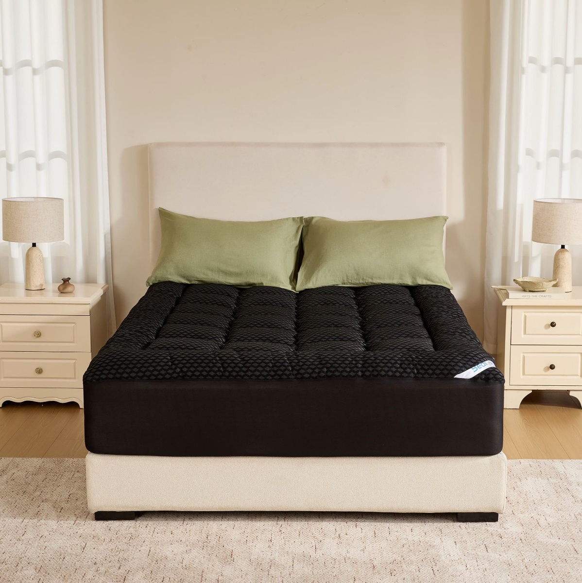 Cooling bamboo mattress topper with sage green pillows on a dark mattress