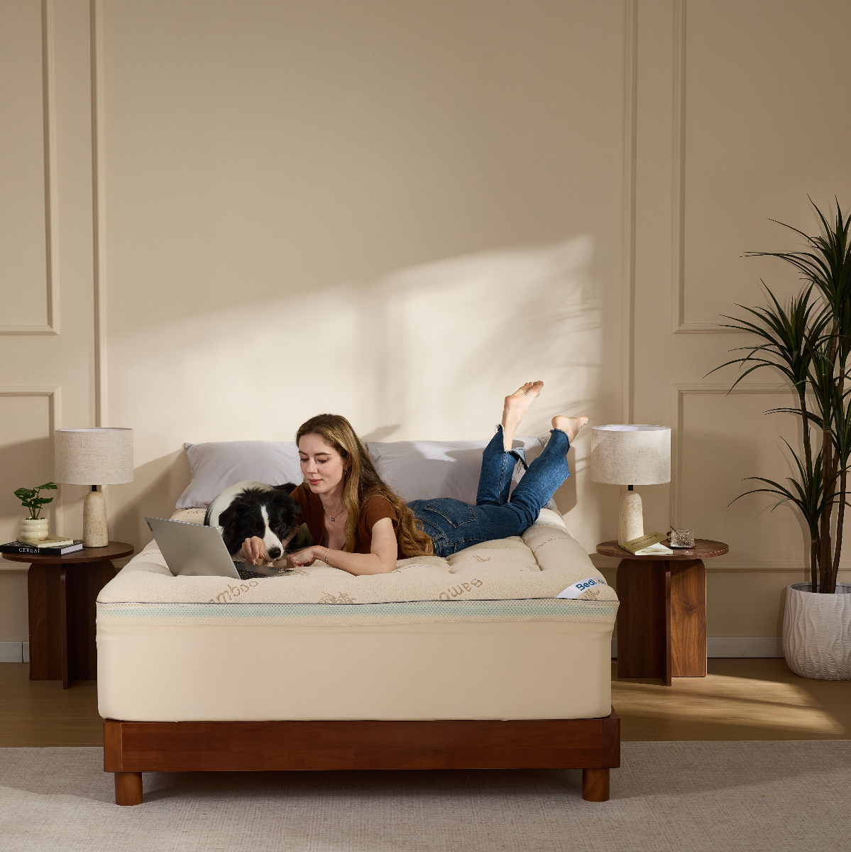 Person relaxing with a dog on a bamboo memory foam mattress topper