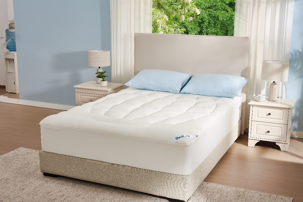 A cool, airy bedroom with soft summer light — sleep cooler this summer with Bedlore