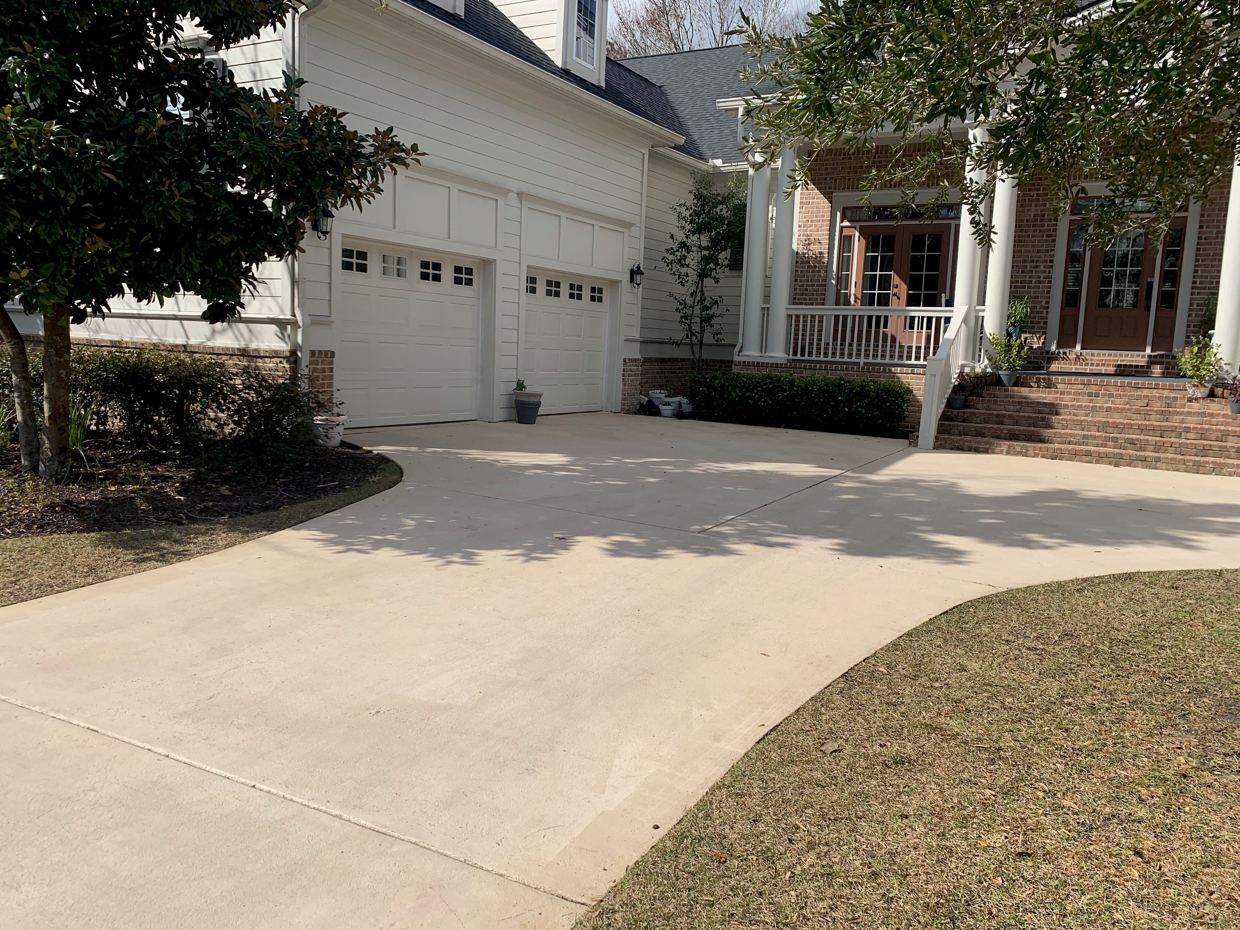 Fan Pattern Stamped Concrete Driveway - Summerville SC Fan pattern stamped concrete driveway in Summerville SC with decorative circular fan design, contrasting border accent, custom color staining, reinforced concrete base, and professional finishing for unique curb appeal in South Carolina residential property