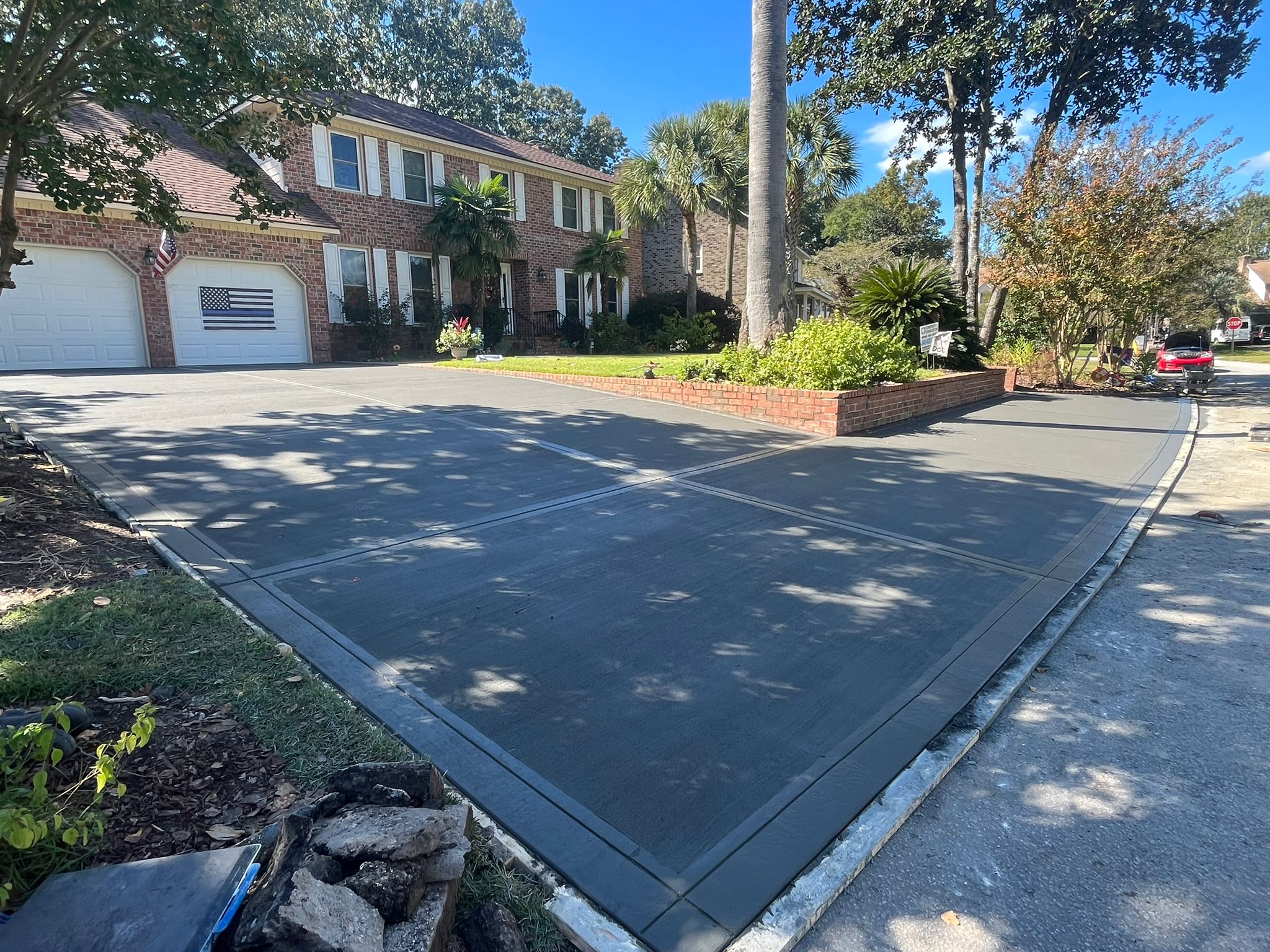 Herringbone Brick Stamped Concrete Driveway - Isle of Palms SC Herringbone brick stamped concrete driveway in Isle of Palms SC with classic herringbone pattern layout, realistic brick texture, red and brown color variations, decorative border design, and durable weather-resistant finish for coastal South Carolina property