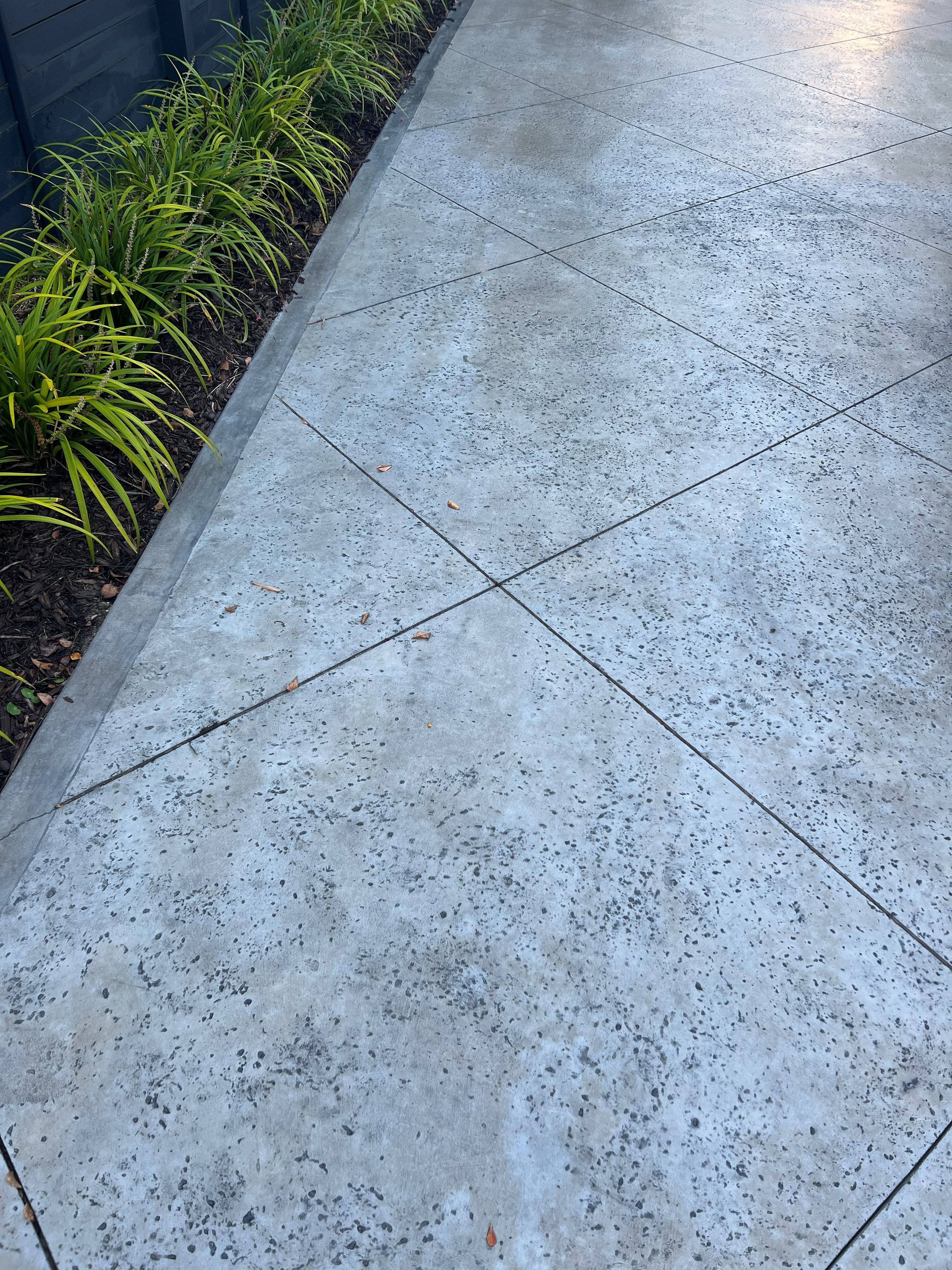 Stamped Concrete Patio Charleston - European Cobblestone Pattern Design Stamped concrete patio in Charleston SC with European fan cobblestone pattern, integral color in sandstone beige, antiquing release agent for authentic aged look, 4-6 inch thickness with steel rebar reinforcement, UV-resistant acrylic sealer, proper drainage slope, control joints for crack prevention, coastal weather durability for Lowcountry outdoor living spaces