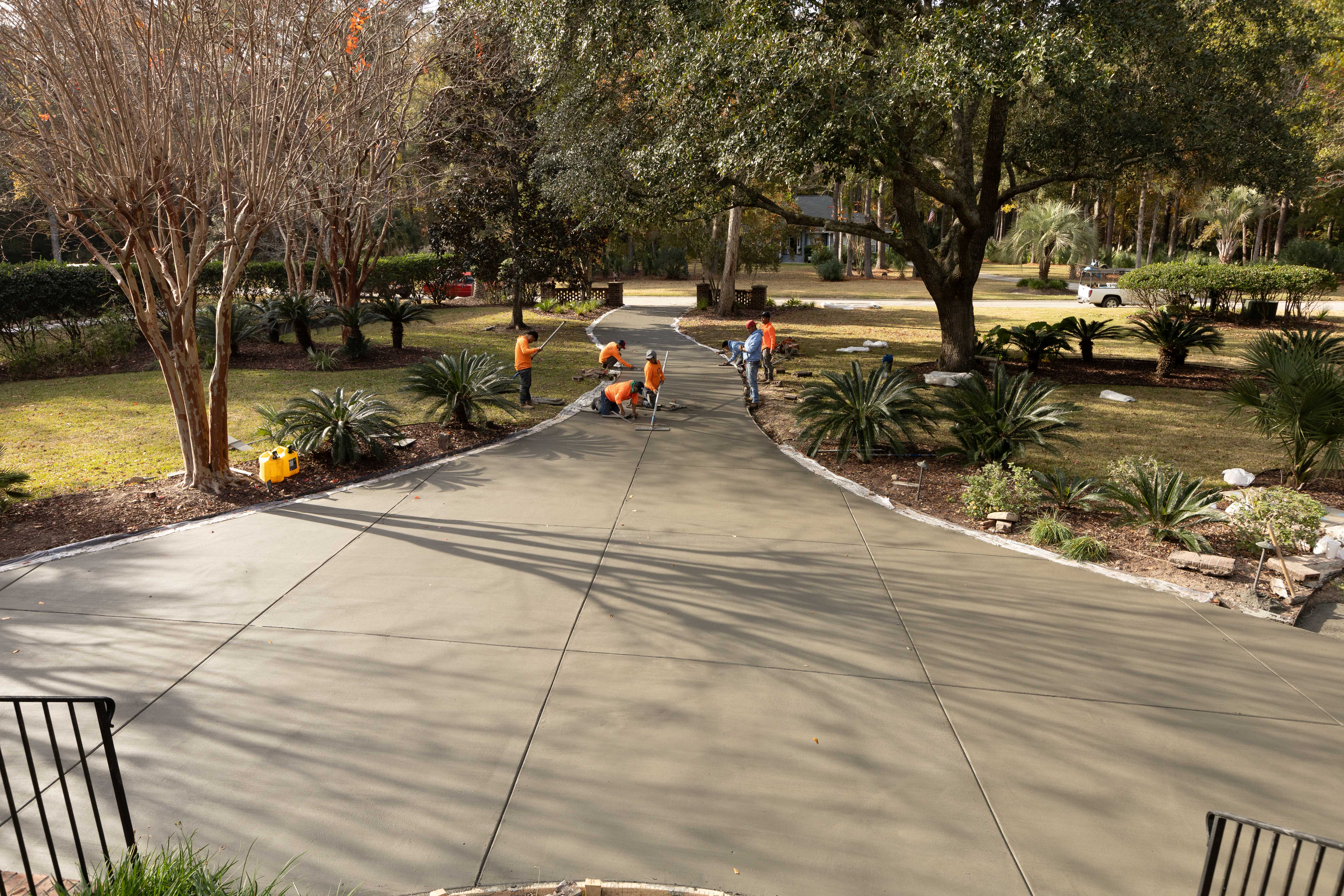 Wood Plank Stamped Concrete Driveway - James Island SC Wood plank stamped concrete driveway in James Island SC featuring realistic wood grain texture pattern, natural brown stain coloring, seamless plank layout, weather-resistant finish, and expert stamping technique for authentic hardwood appearance in Charleston Lowcountry