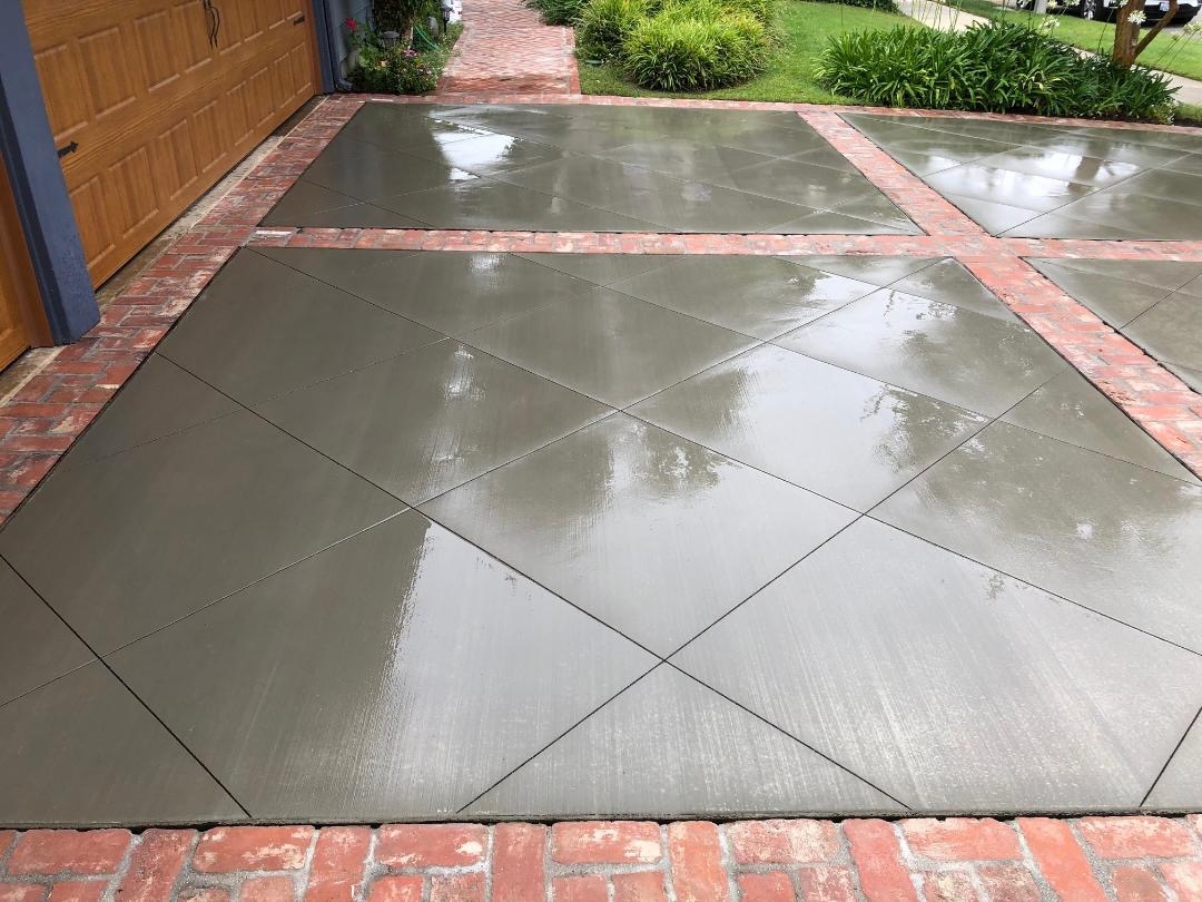 Colored Decorative Driveway James Island - Stamped Slate Pattern Concrete Colored stamped concrete driveway in James Island SC with ashlar slate pattern, integral terra cotta color with charcoal accents, 4000 PSI concrete with fiber reinforcement, 5-6 inch thickness for vehicle loads, high-gloss wet look sealer, UV resistant finish, humidity and coastal weather protection, custom border design, professional Lowcountry installation