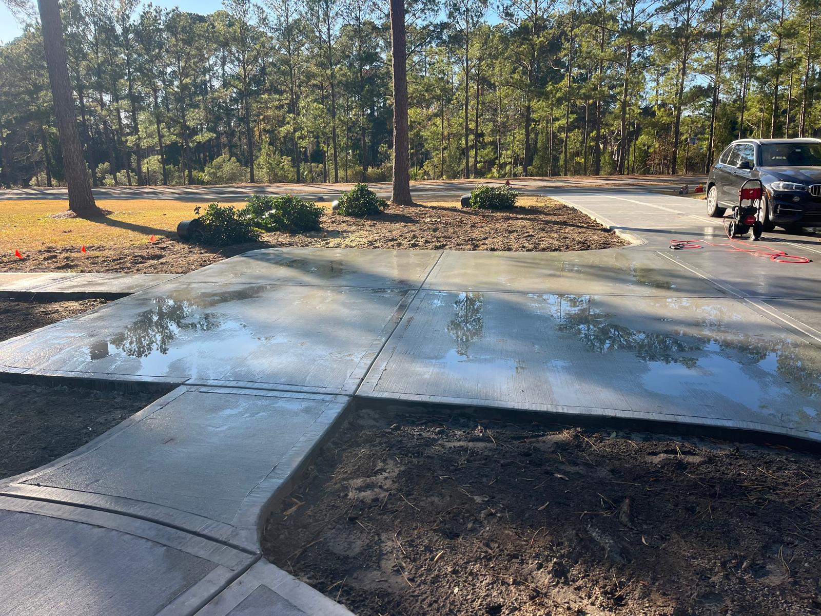 European Cobblestone Stamped Concrete Driveway - West Ashley SC European cobblestone stamped concrete driveway in West Ashley SC with authentic European cobblestone pattern, aged stone appearance, multi-color antiquing stain, textured non-slip surface, and professional installation for Old World charm in Charleston residential property