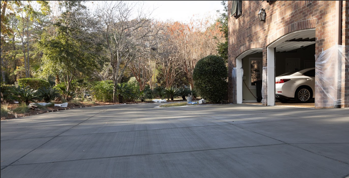 Polished Concrete Driveway - Mount Pleasant SC Polished concrete driveway in Mount Pleasant SC featuring smooth glossy finish, diamond-polished surface, modern minimalist aesthetic, high-gloss sealer protection, reinforced construction, and professional grinding technique for contemporary residential property in Charleston area