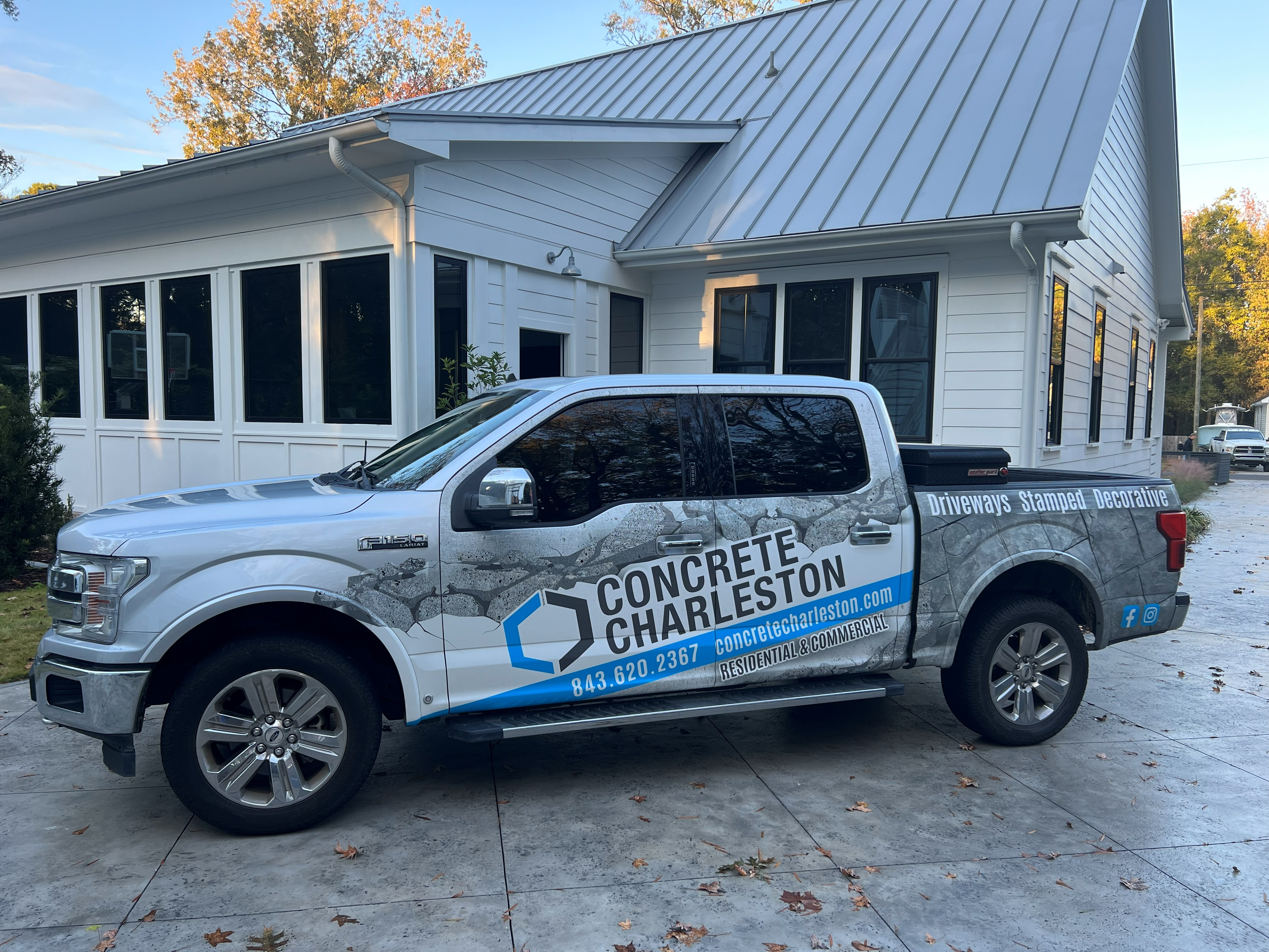Concrete Charleston crew pouring and finishing fresh concrete for residential driveway in Charleston SC, demonstrating professional concrete installation techniques with proper grading, reinforcement, and smooth finishing for long-lasting durability