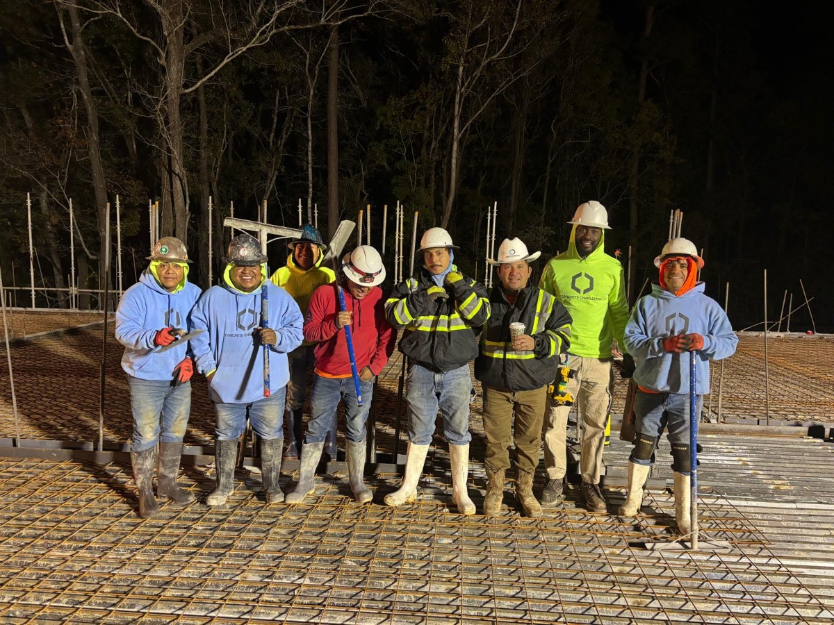 Professional concrete contractor team at Concrete Charleston working on residential driveway project in Charleston SC Lowcountry, showing expert craftsmanship and quality workmanship with modern concrete finishing equipment and techniques