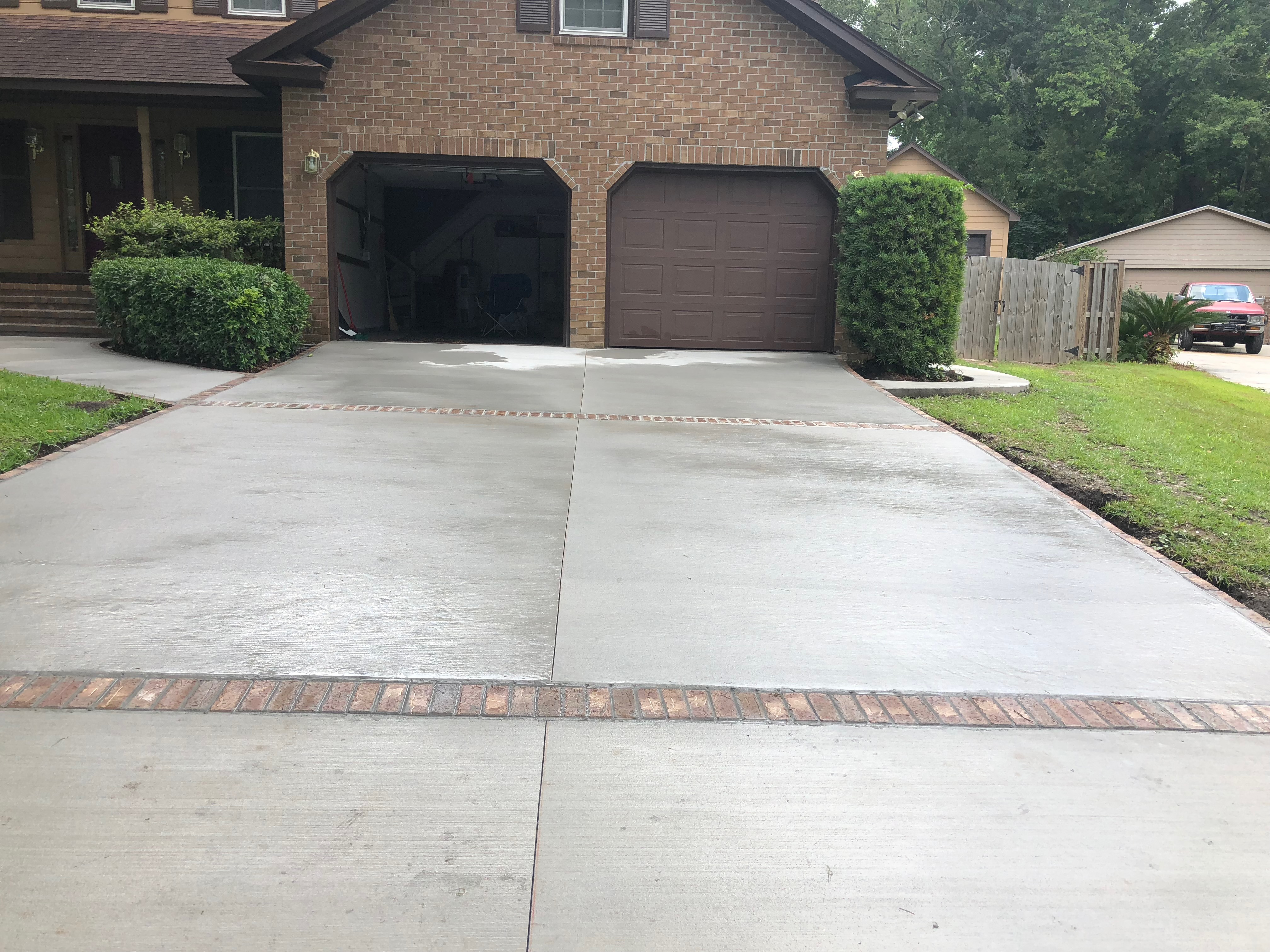 Ashlar Slate Stamped Concrete Driveway - Charleston SC Ashlar slate concrete driveway in Charleston SC with large format slate stone pattern, random ashlar layout, multi-color acid stain finish, textured non-slip surface, steel reinforcement, and expert craftsmanship for luxury residential property in Lowcountry area