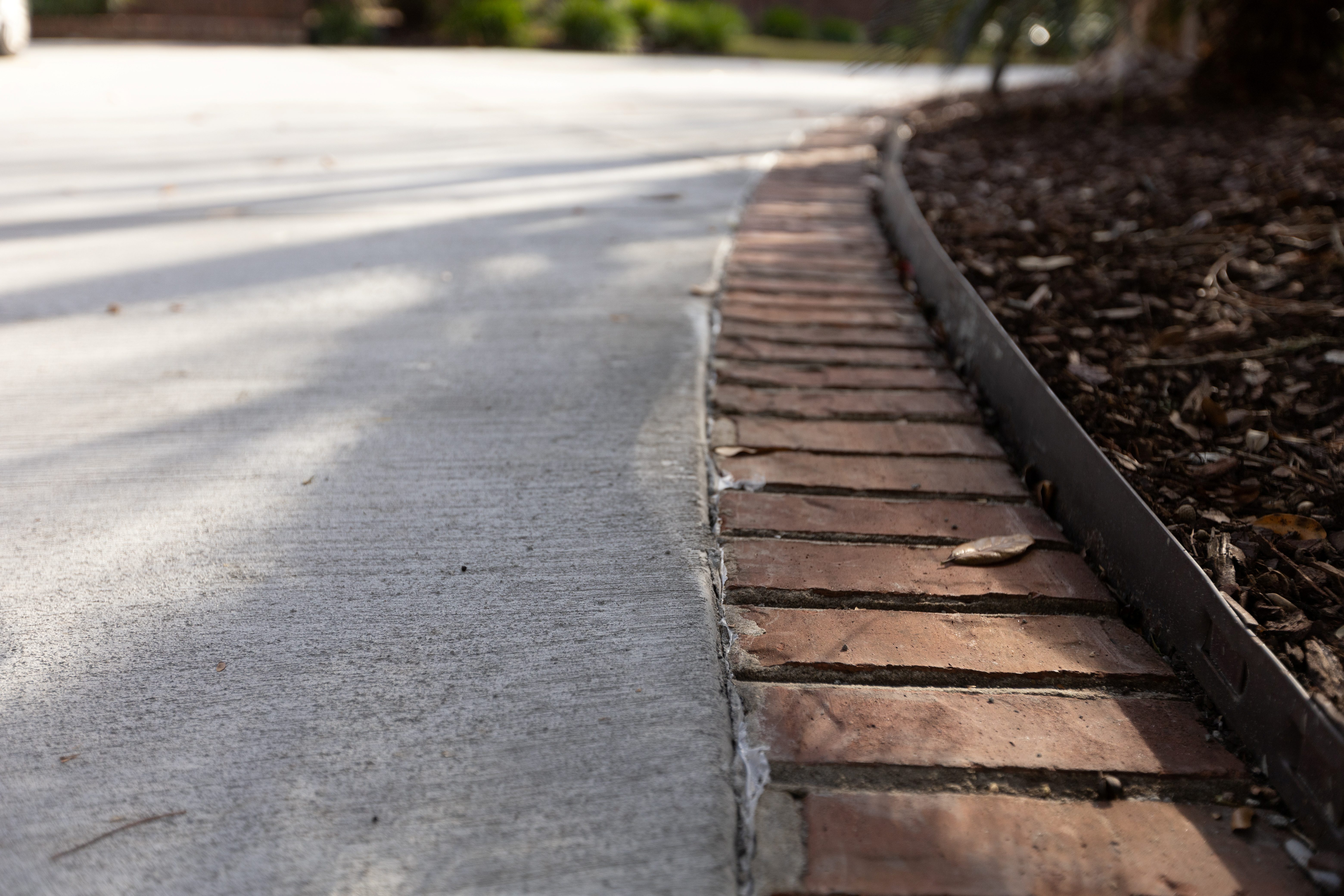 Flagstone Stamped Patio Mount Pleasant - Natural Stone Pattern Decorative Concrete Stamped concrete patio in Mount Pleasant SC with irregular flagstone pattern, integral sandstone color with brown release agent, random stone layout for natural appearance, 4-6 inch thickness with steel rebar reinforcement, textured surface for slip resistance, UV-resistant acrylic sealer, coastal weather durability, custom outdoor living space design for Lowcountry homes