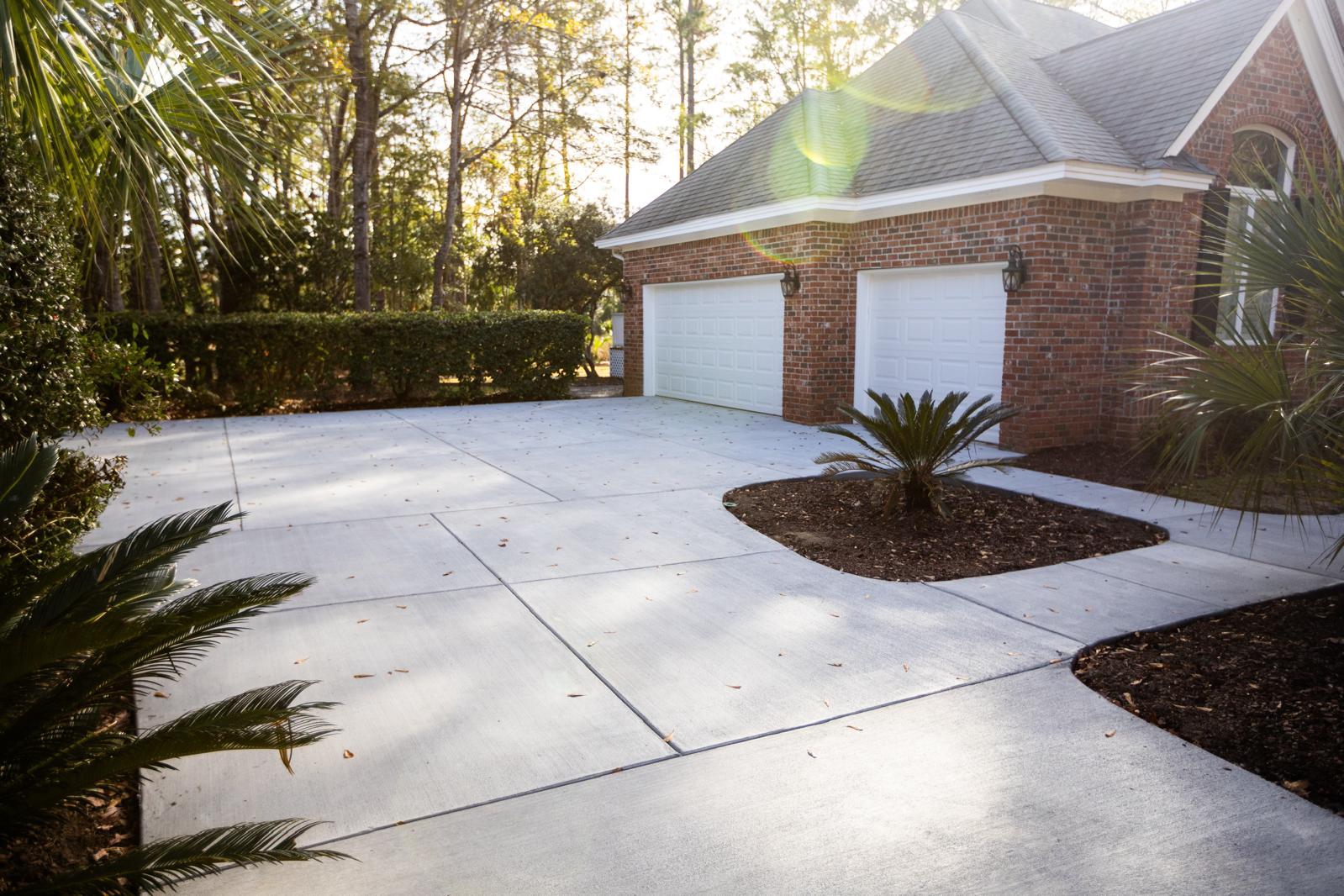 Random Stone Stamped Concrete Driveway - James Island SC Random stone stamped concrete driveway in James Island SC featuring natural fieldstone pattern, irregular stone shapes, multi-tone color staining, realistic rock texture, weather-resistant sealer, and expert stamping for authentic stone appearance in Charleston area