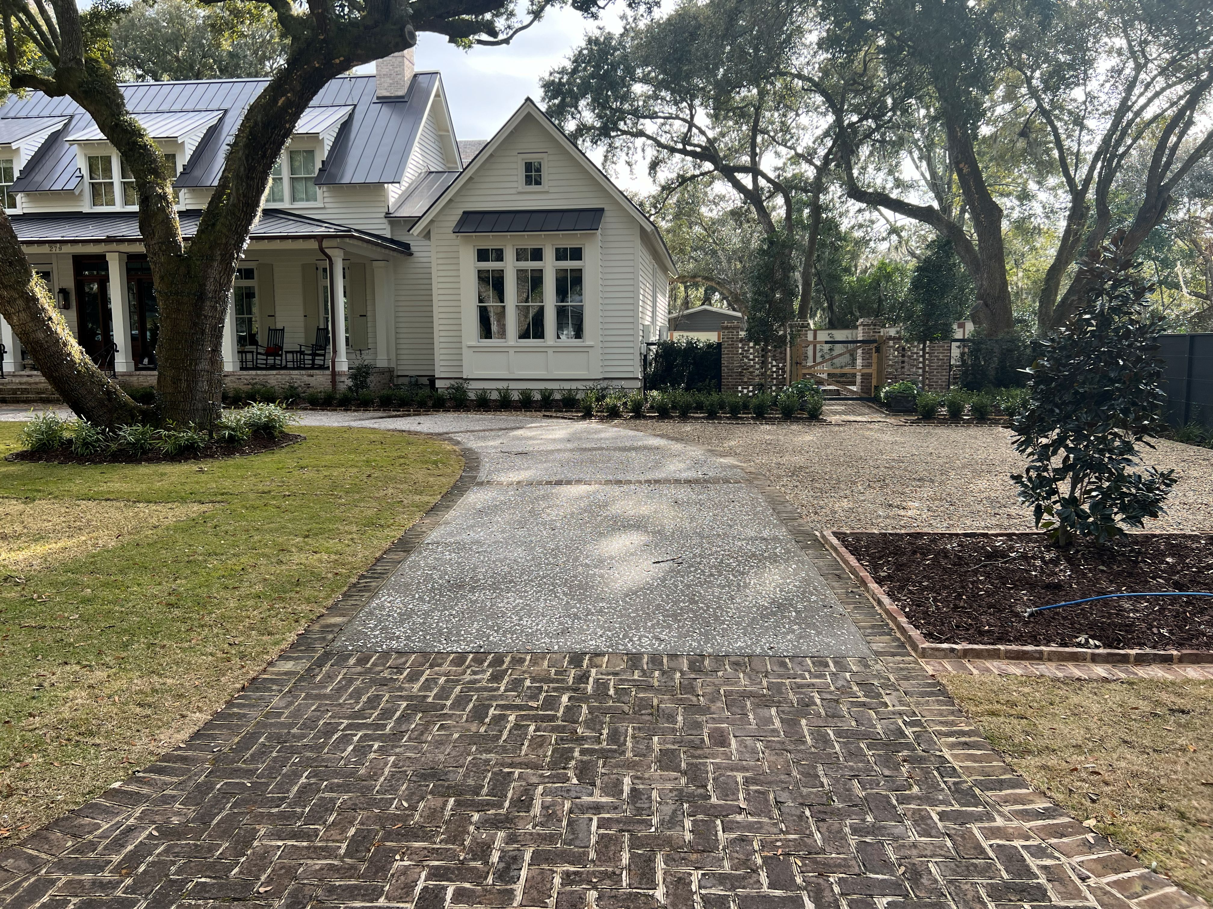 Decorative Garage Floor Daniel Island - Metallic Epoxy Concrete Coating Decorative concrete garage floor in Daniel Island SC with metallic epoxy coating in charcoal gray, diamond ground surface preparation, moisture vapor barrier, high-build epoxy with decorative flakes, polyaspartic topcoat for UV resistance, chemical and oil stain resistant, 4500 PSI concrete base, humidity resistant for Charleston coastal climate, durable residential flooring