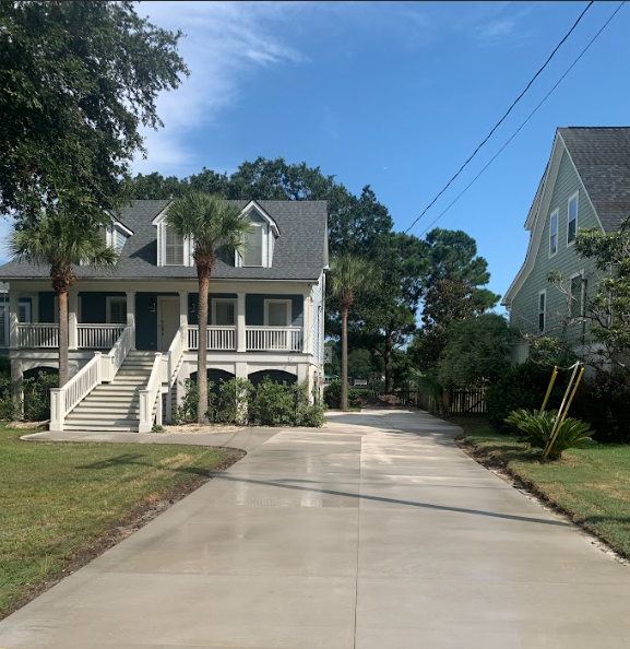 Acid Stained Concrete Driveway - Daniel Island SC Acid stained concrete driveway in Daniel Island SC featuring custom chemical stain coloring, variegated earth-tone finish, marbled color effect, smooth trowel surface, high-gloss sealer, and artistic concrete finishing for unique residential driveway in Charleston Lowcountry