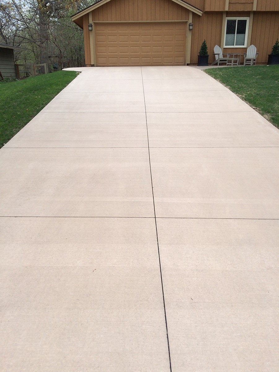 Broom Finish Concrete Driveway - Summerville SC Broom finish concrete driveway in Summerville SC with classic textured broom finish for slip resistance, uniform gray color, proper control joints, steel rebar reinforcement, 4-inch thickness, and professional installation for durable residential driveway in South Carolina