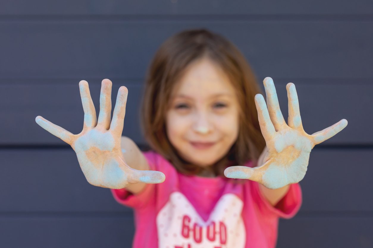 Young girl enjoying chalk art on professional concrete driveway installation in Charleston SC showcasing durable and family-friendly concrete surfaces